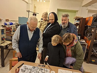 Uldis Bērziņš vēro kolēģu demonstrēto alumīnija parauga levitāciju laboratorijas telpās Šķūņu ielā 4